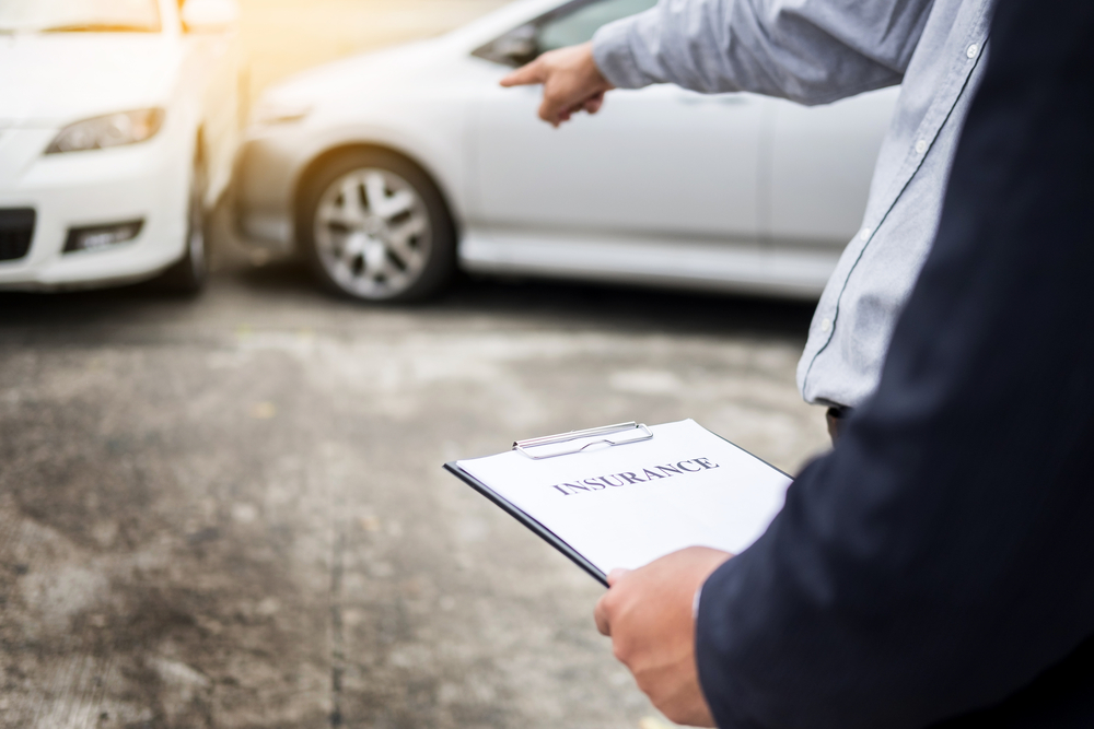 Insurance adjuster examining car accident